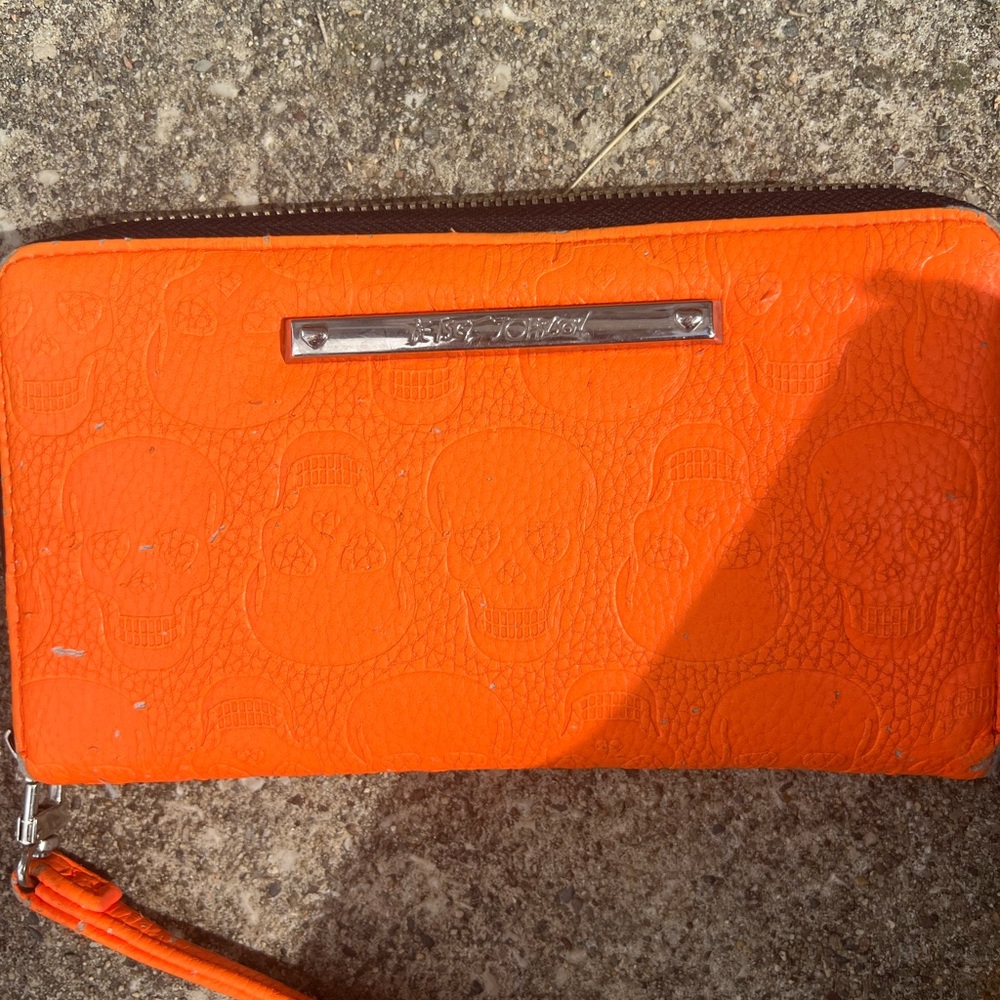Orange Betsey Johnson wallet with skulls